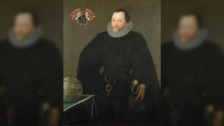 Portrait of Sir Francis Drake. He has short cropped hair and a pointed beard and moustache. He is wearing black clothing, a bit white colour and a long black cloak. Around his wasist he is wearing the Drake Jewel or Drake Pendant. In the top left corner there is a coat of arms.