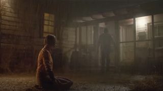 A screenshot from Foe's trailer of it raining and Jr. running inside while Hen sits outside.