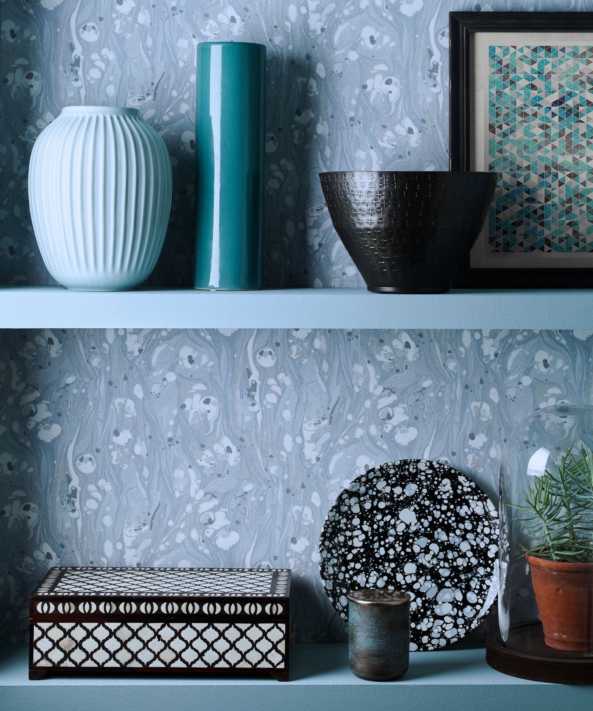 Living room with blue wallpaper and shelving