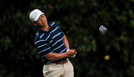 Luke Kwon watches his tee shot with a driver