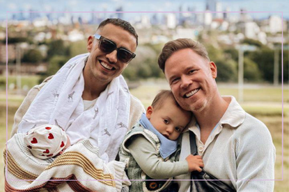 Francis Haugen (left) holding newborn Rebel and Stuart Armfield (right) holding son, Rio
