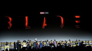 A zoomed out shot of Marvel actors and creators on stage during Marvel's Comic Con 2019 panel in Hall H