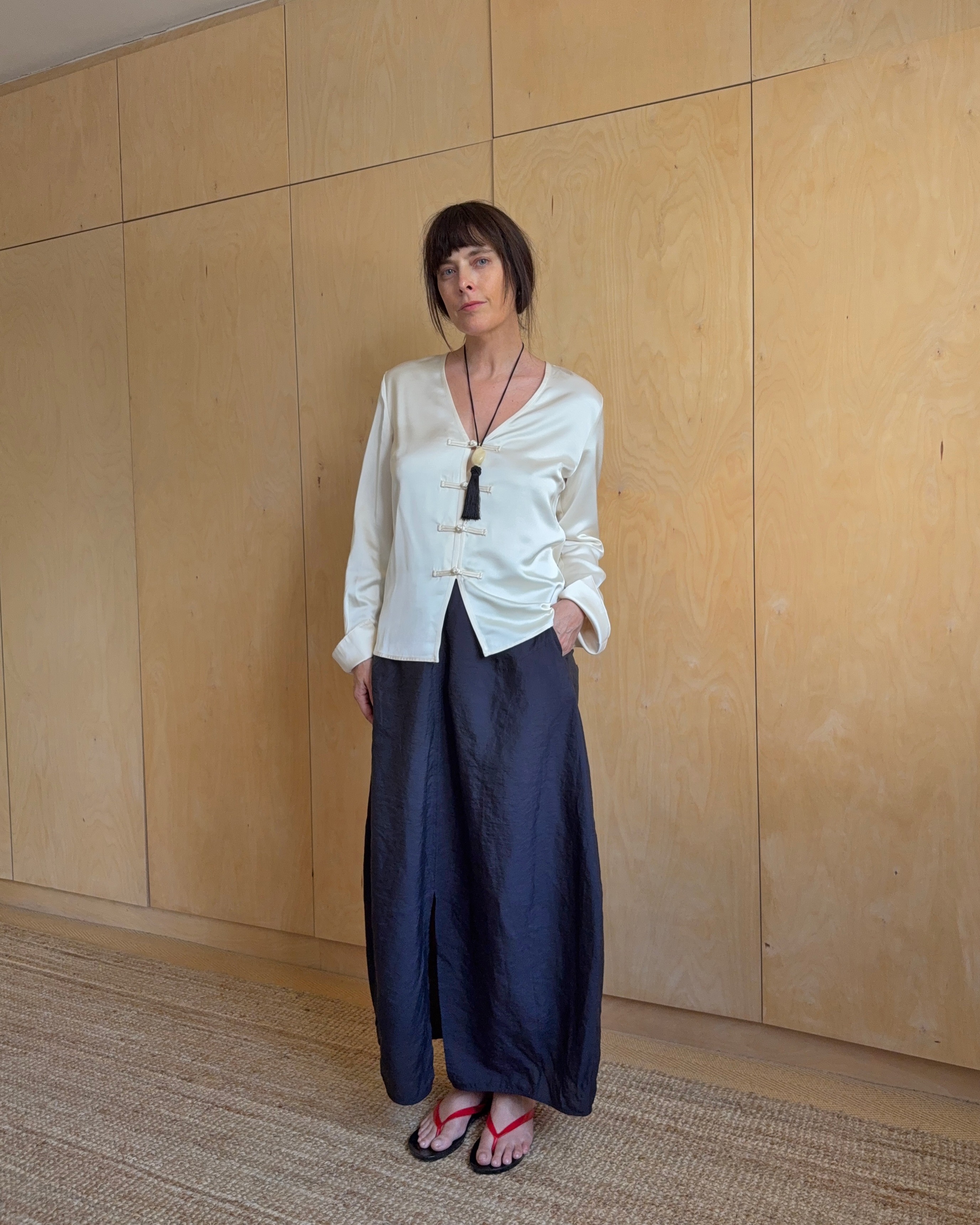 Woman wears cream aligne knot tie shirt