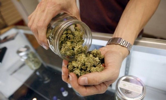 A &amp;quot;budtender&amp;quot; pours marijuana from a jar at a medical marijuana dispensary in Los Angeles in 2012. Soon, this will all be perfectly legal in Uruguay.