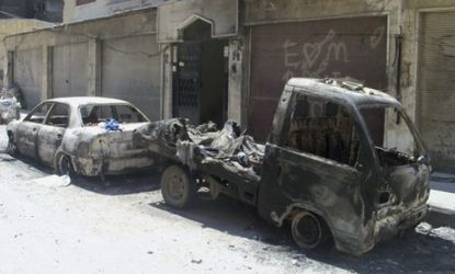 Damaged vehicles are seen in Homs Tuesday: President Bashar al-Assad's disregard for the U.N. peace agreement is apparent by the continued shelling of Syrian civilians.