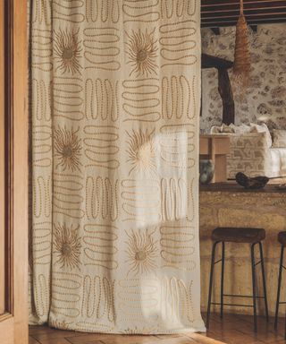 embroidered patterned curtain with sun print in living space