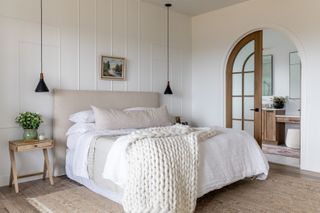 Farmhouse bedroom designed by House of Jade with white wool blankets