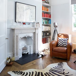 fire place with leather sofa and book shelf
