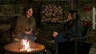 Nicolle and Monica Danus, sitting around an outdoor fire at night, in episode 808 of Love Is Blind.