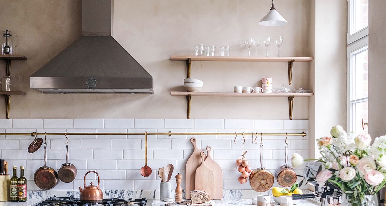 relaxed looking kitchen with open shelves and plaster walls