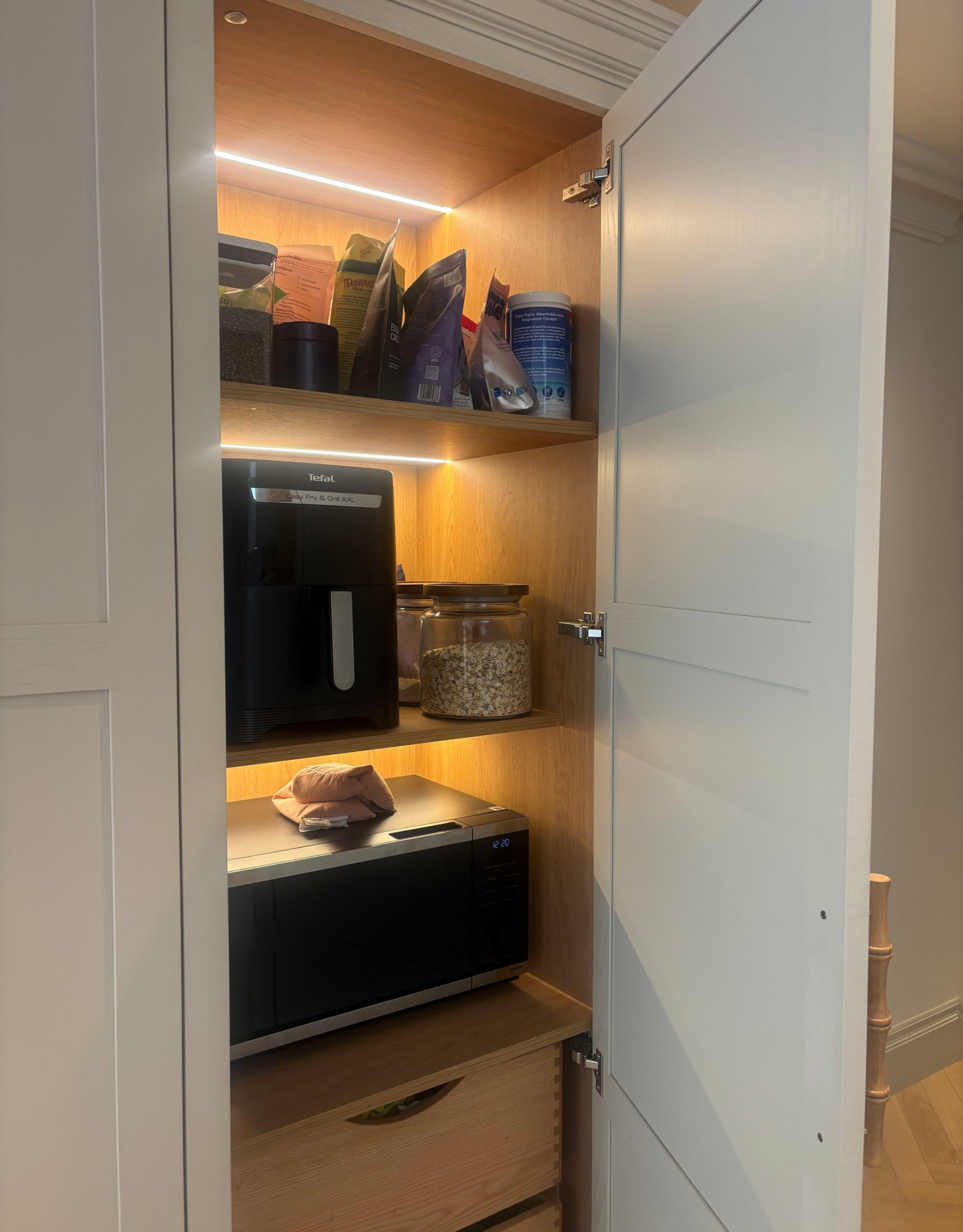 Hidden pantry with microwave and coffee machine within