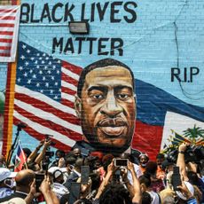 Press photographing wall mural of George Floyd