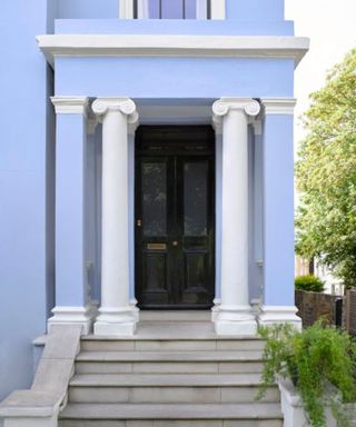 home exterior painted pastel blue with black front door