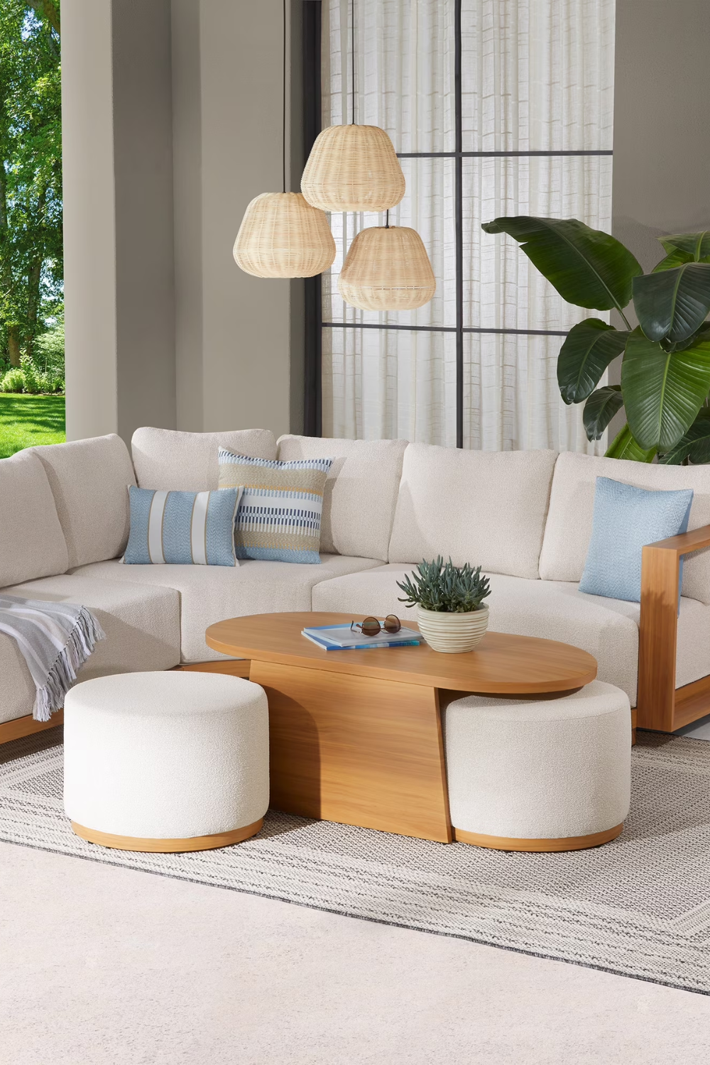 Coastal-inspired outdoor living room featuring Walmart's Juliet space-saving seating group styled with a potted plant, book, and pair of sunglasses