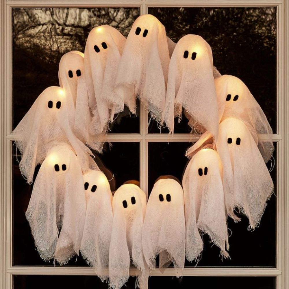 Ghosts wreath with lights on a glazed door