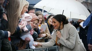 Meghan Markle greeting a baby