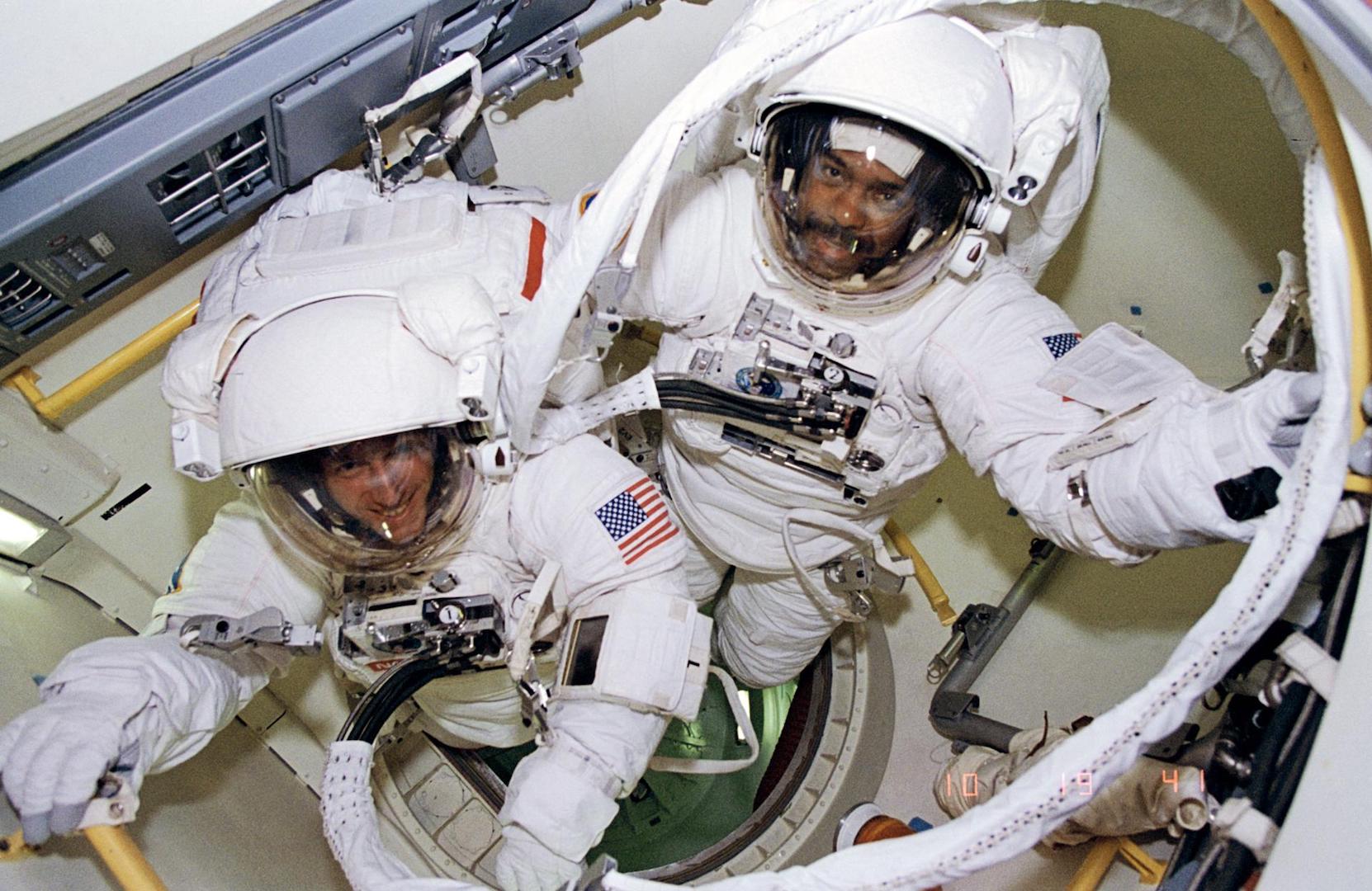 two astronauts floating in space