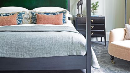 four poster bed in bedroom with blue and white bedding