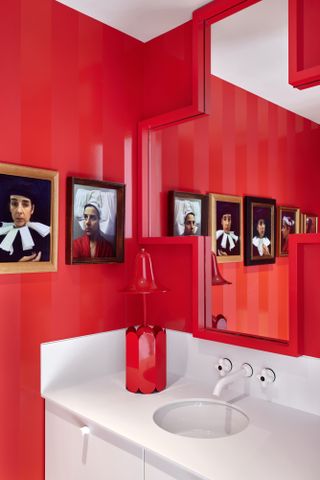 bathroom with red walls and mirror