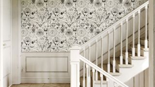 gothic wallpaper on staircase with white wood panelling