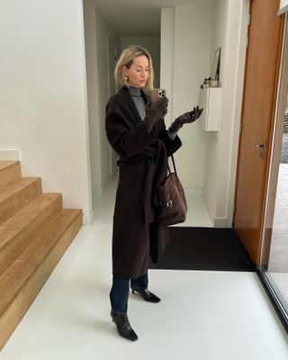 woman in long coat and kitten heel boots