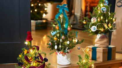 mini christmas tree decorated with festive lights and decorations