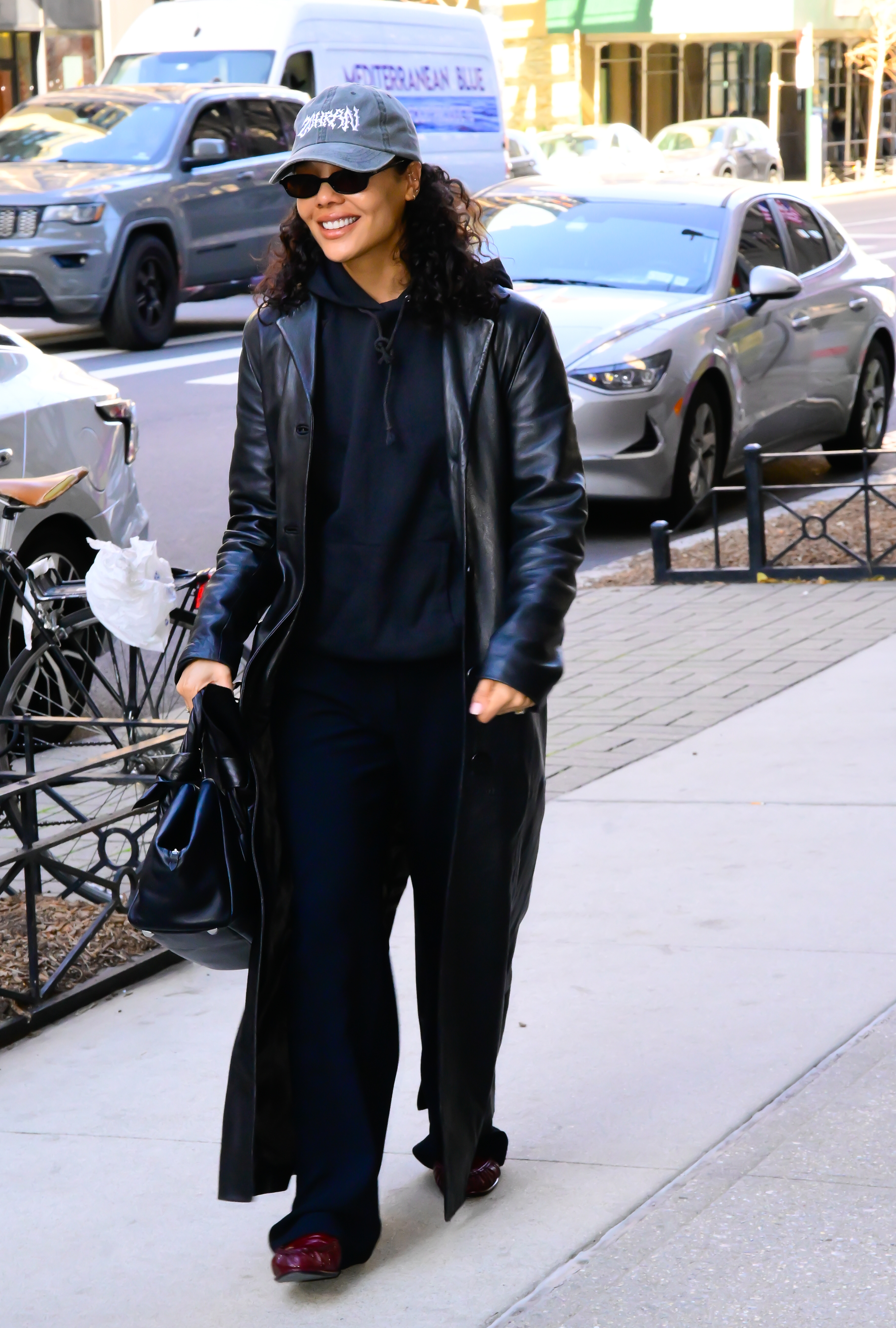 Tessa Thompson wearing an all-black outfit and burgundy loafers