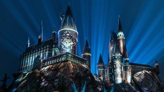 Hogwarts lit up with the nighttime lights at Universal Orlando. 