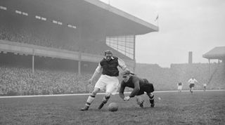 2nd April 1938: Sam Bartram, the Charlton Athletic goalkeeper dives at the feet of Arsenal's Ted Drake during a match at Highbury in north London. (Photo by Central Press/Getty Images)