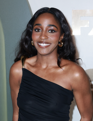 Ayo Edebiri attends the Walt Disney Company Post-Emmys® Celebration on September 15, 2024 in Los Angeles, California wearing a one-shoulder black dress from bottega veneta