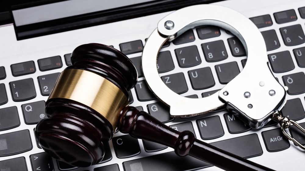 gavel and handcuffs on keyboard