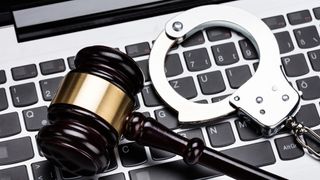 gavel and handcuffs on keyboard