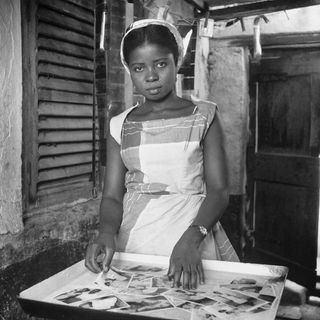 Evelyn Abbew washing prints at the Ever Young Studio,c. 1954–56