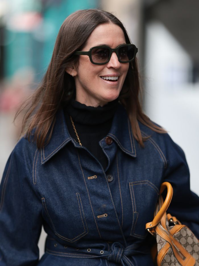 A woman at London Fashion Week with a lob haircut wearing a dark denim shirt