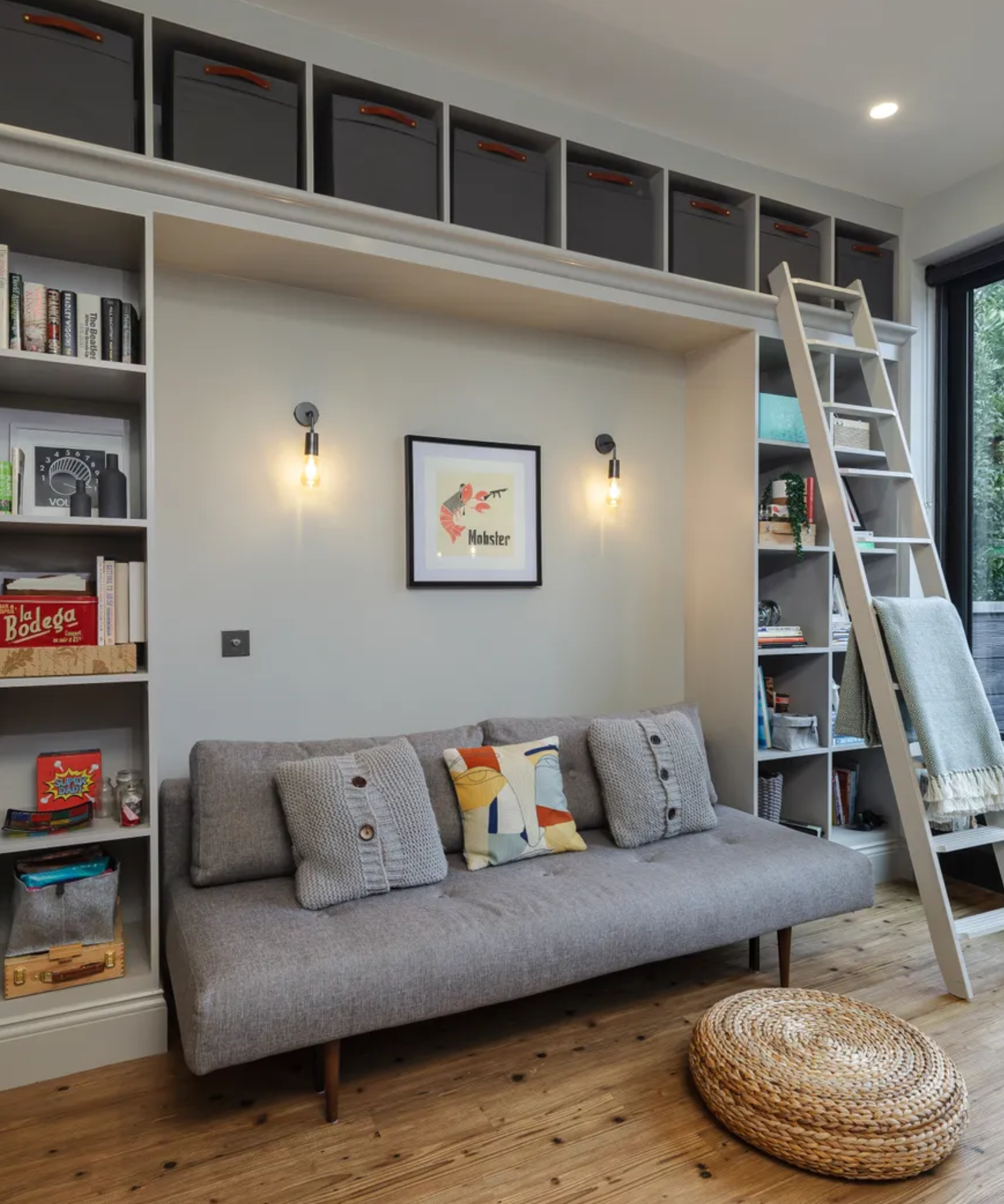Sofa with built in storage boxes around it with a ladder to the top ones