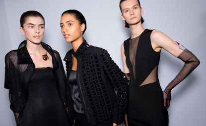 Models wear black shirt and top, black jacket and top, and black top and trousers