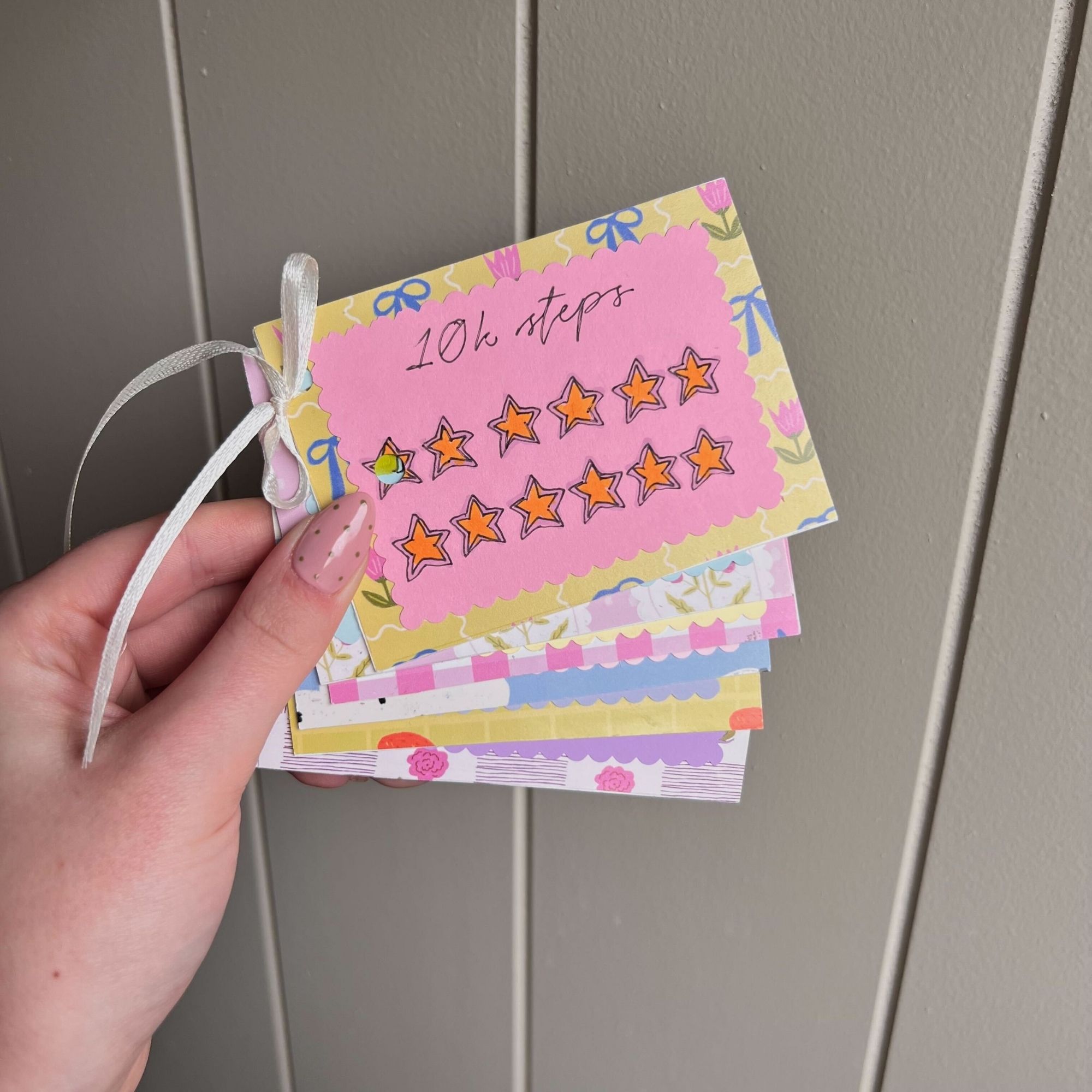 Layla Al-Ani holding the punch cards she made.