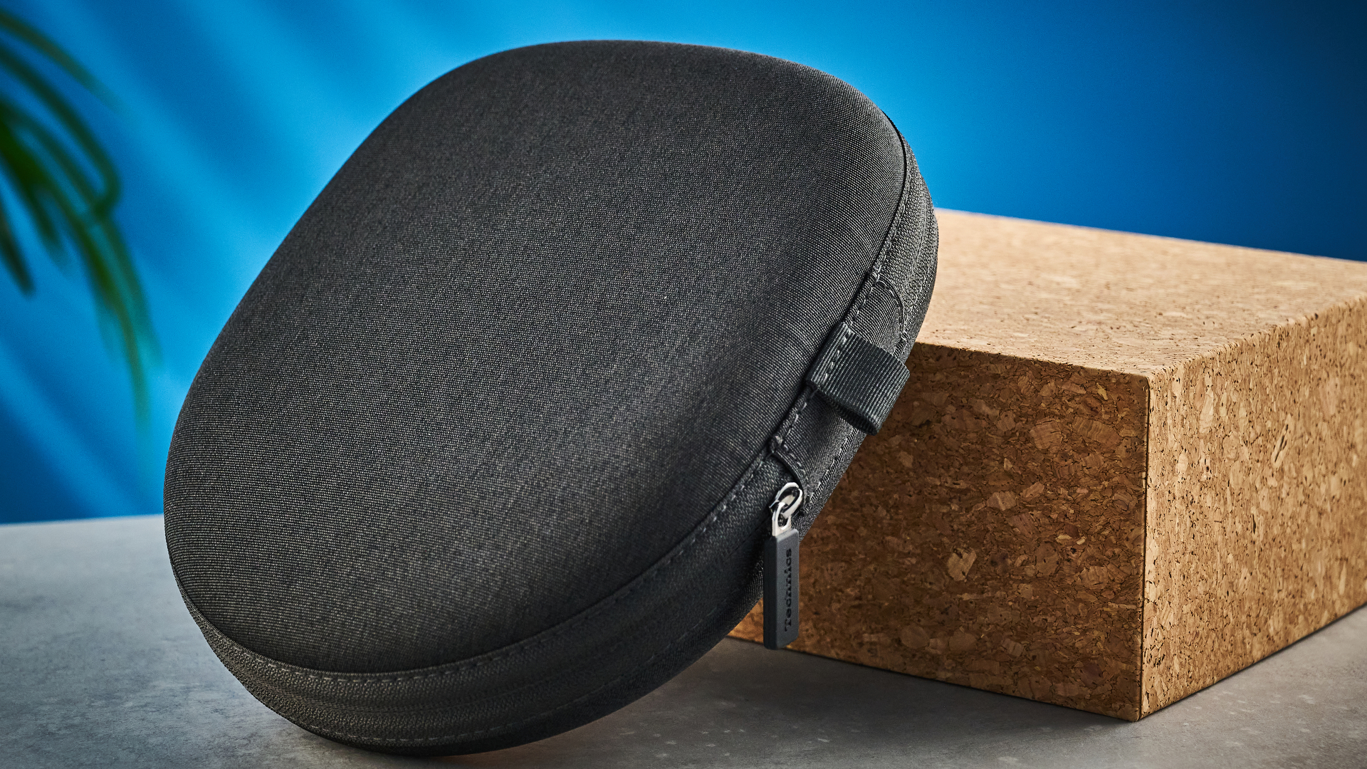 the technics eah-a1000 headphones with a gold technics logo photographed against a blue background