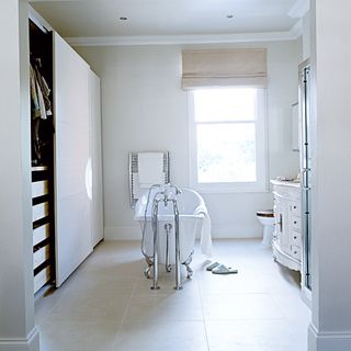 bathroom with white walls and bathtub