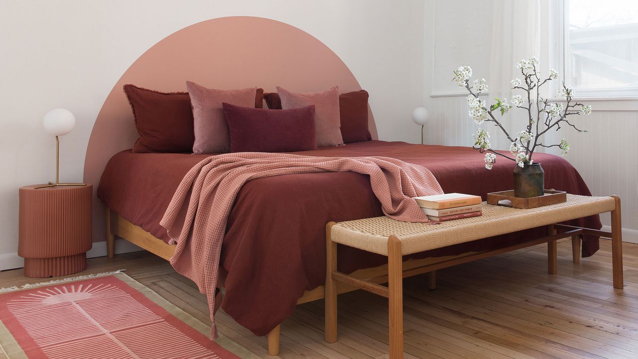 a bedroom with a painted semicircle headboard