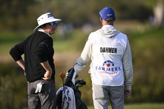 Joel Dahmen chats to his caddie during the Farmers Insurance Open