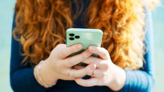 A woman holding a smartphone