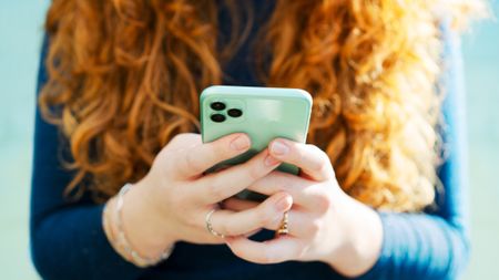 A woman holding a smartphone
