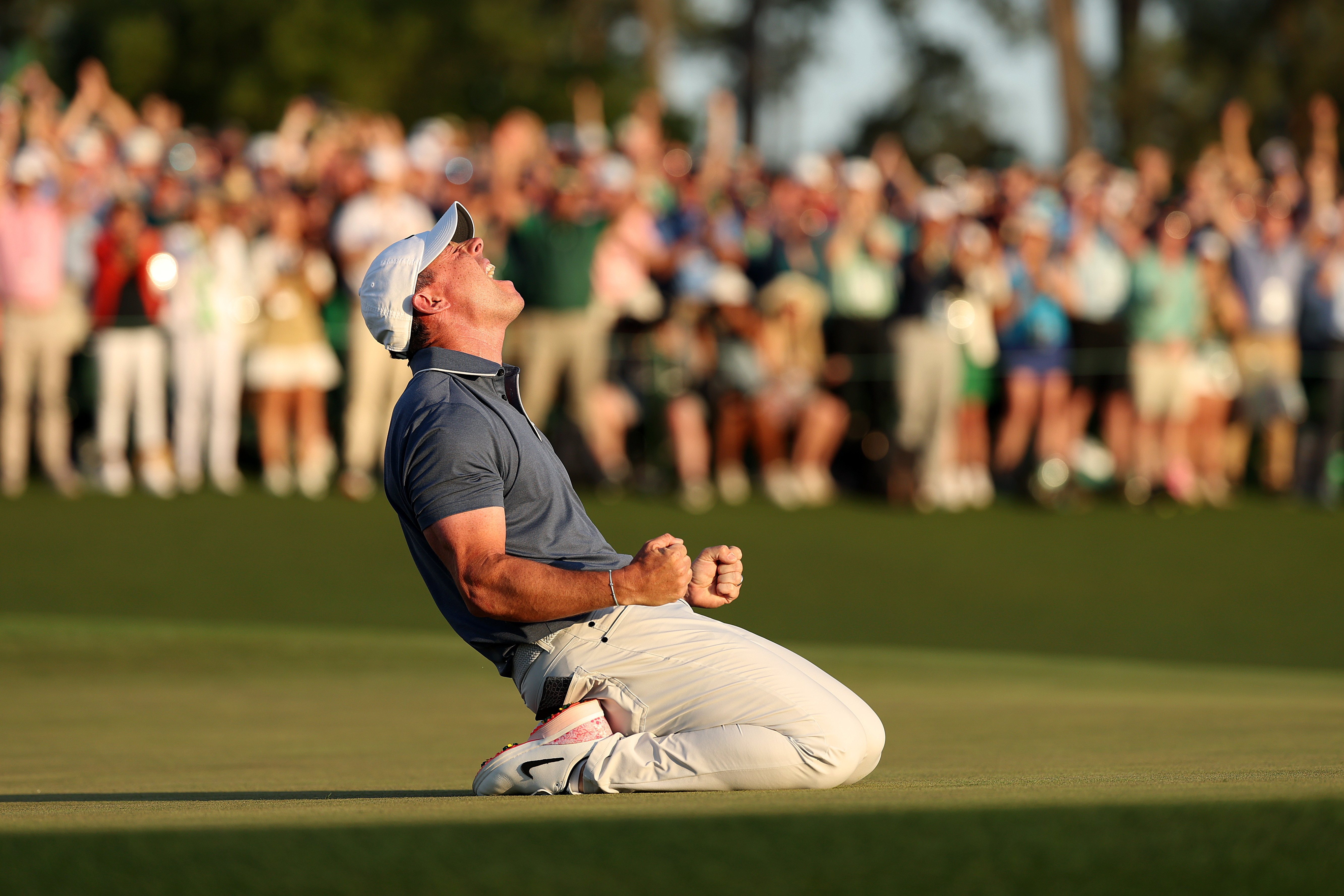 Rory McIlroy collapses to the floor after winning The Masters at Augusta to complete the career Grand Slam in 2025