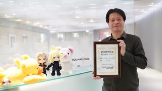 Yoshinori Kitase, producer on FF7 Remake, holding a commemorative certificate marking Final Fantasy 7 Day.