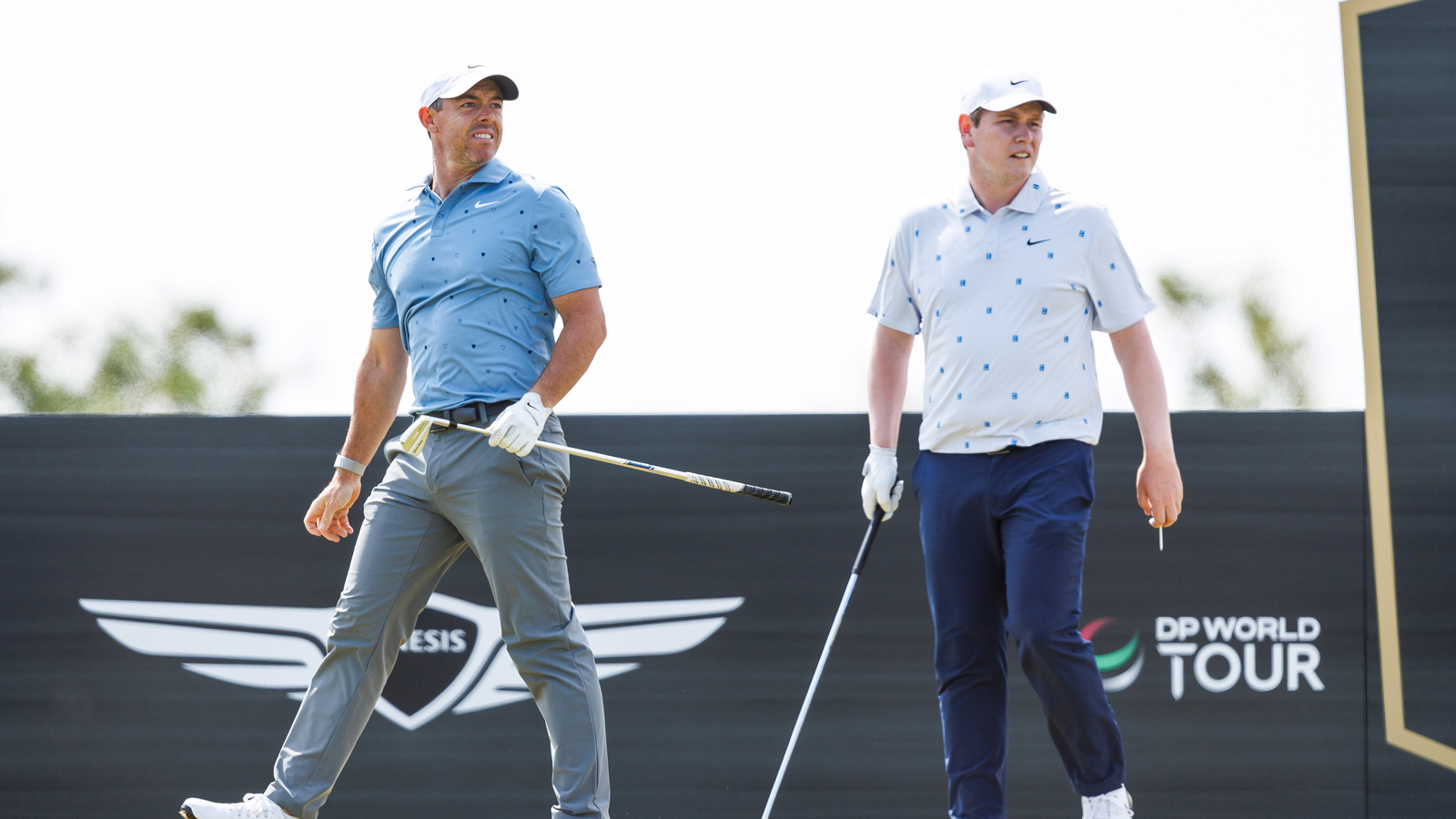 Rory McIlroy and Robert MacIntyre watch a tee shot