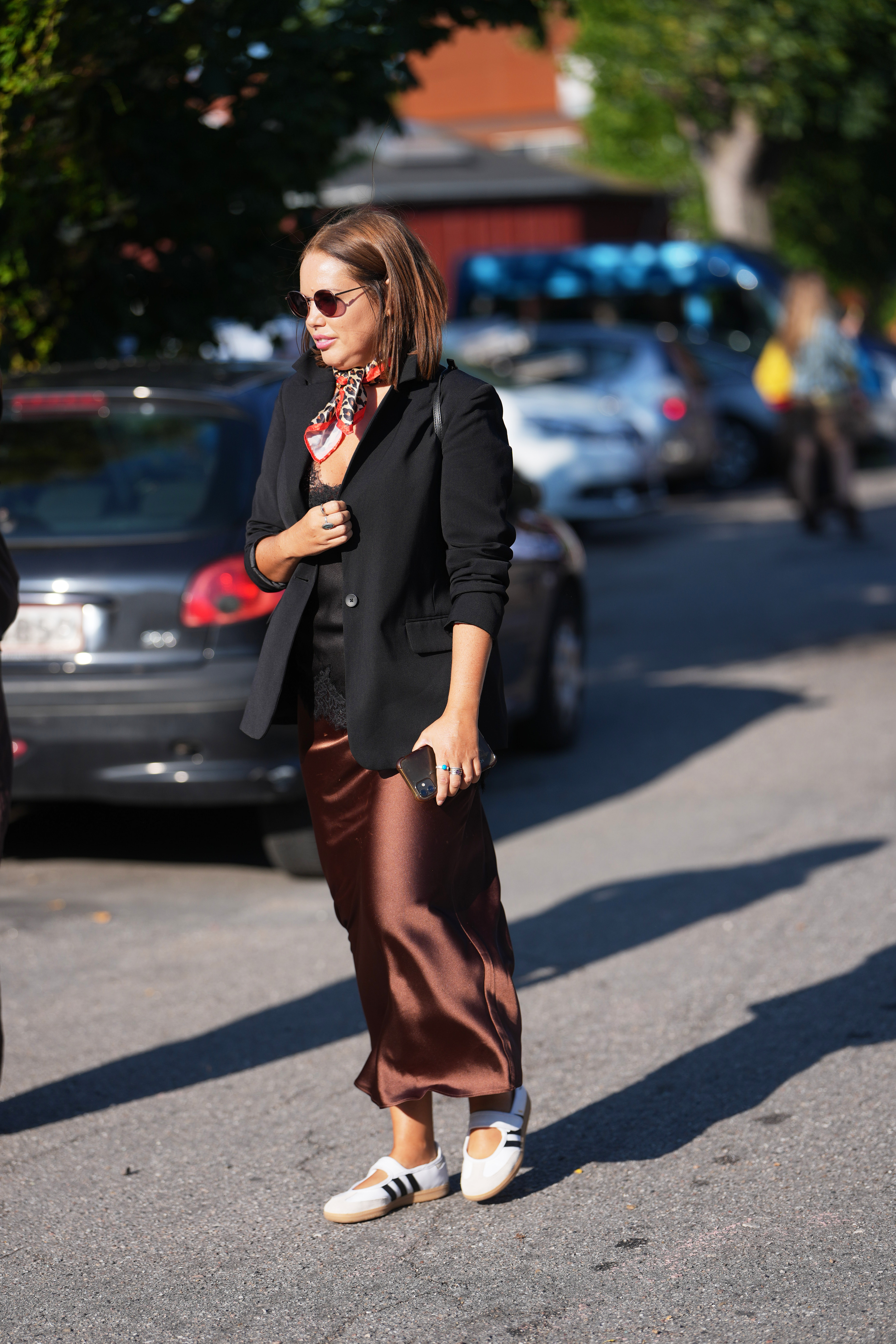 Woman in a satin skirt and sneakers