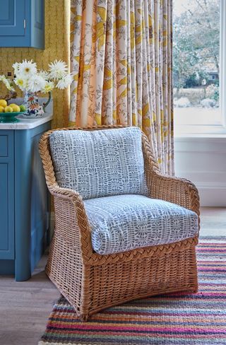 wicker chair in country kitchen with curtains