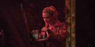 Millie Kessler (Kathryn Newton) holds a chainsaw while bathed in red light in 'Freaky'