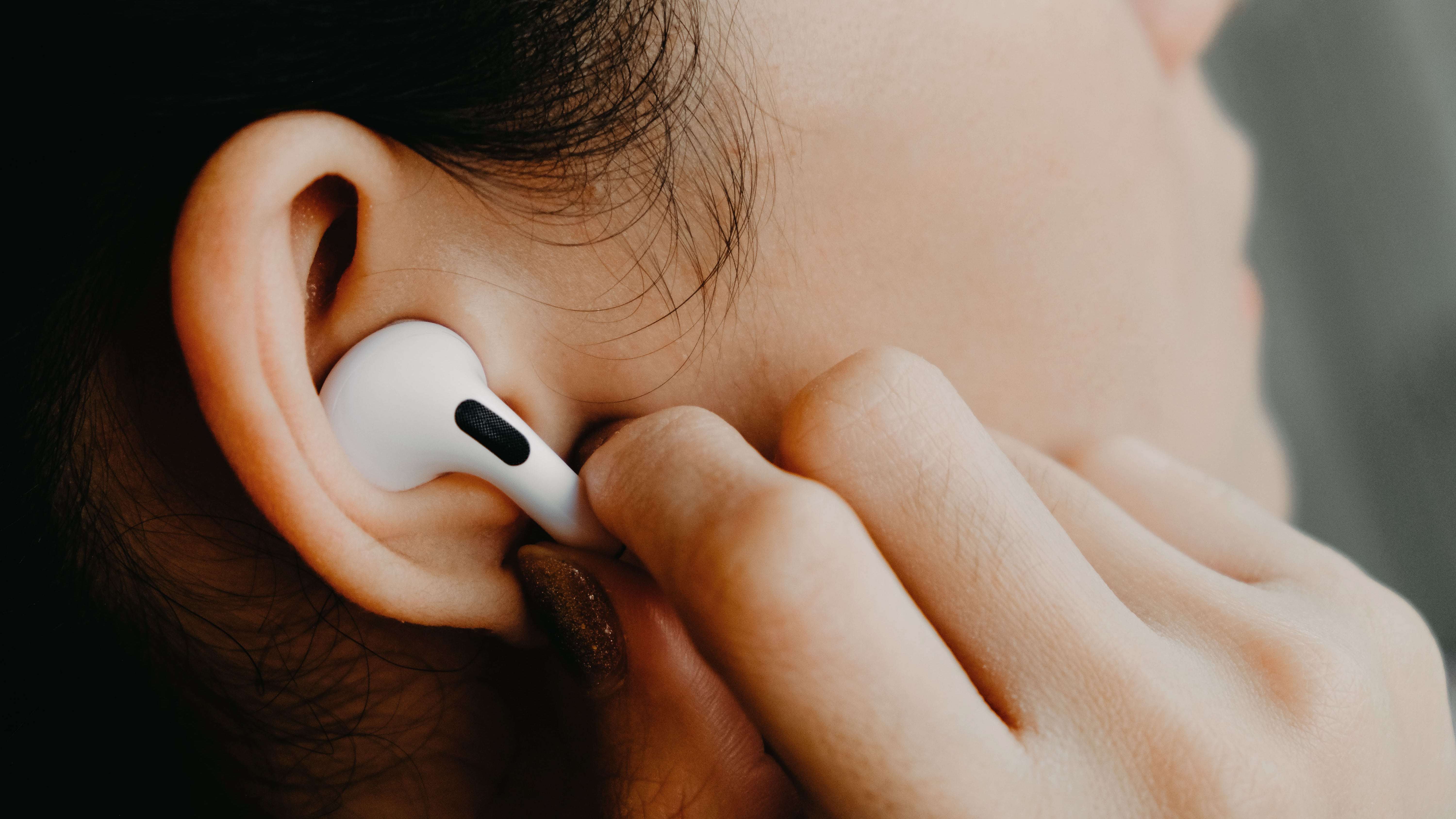 Close-up of woman using AirPods Pro 2